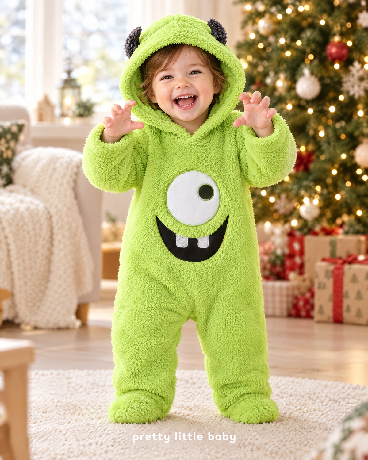 Toddler in Little Monster romper by the Christmas tree